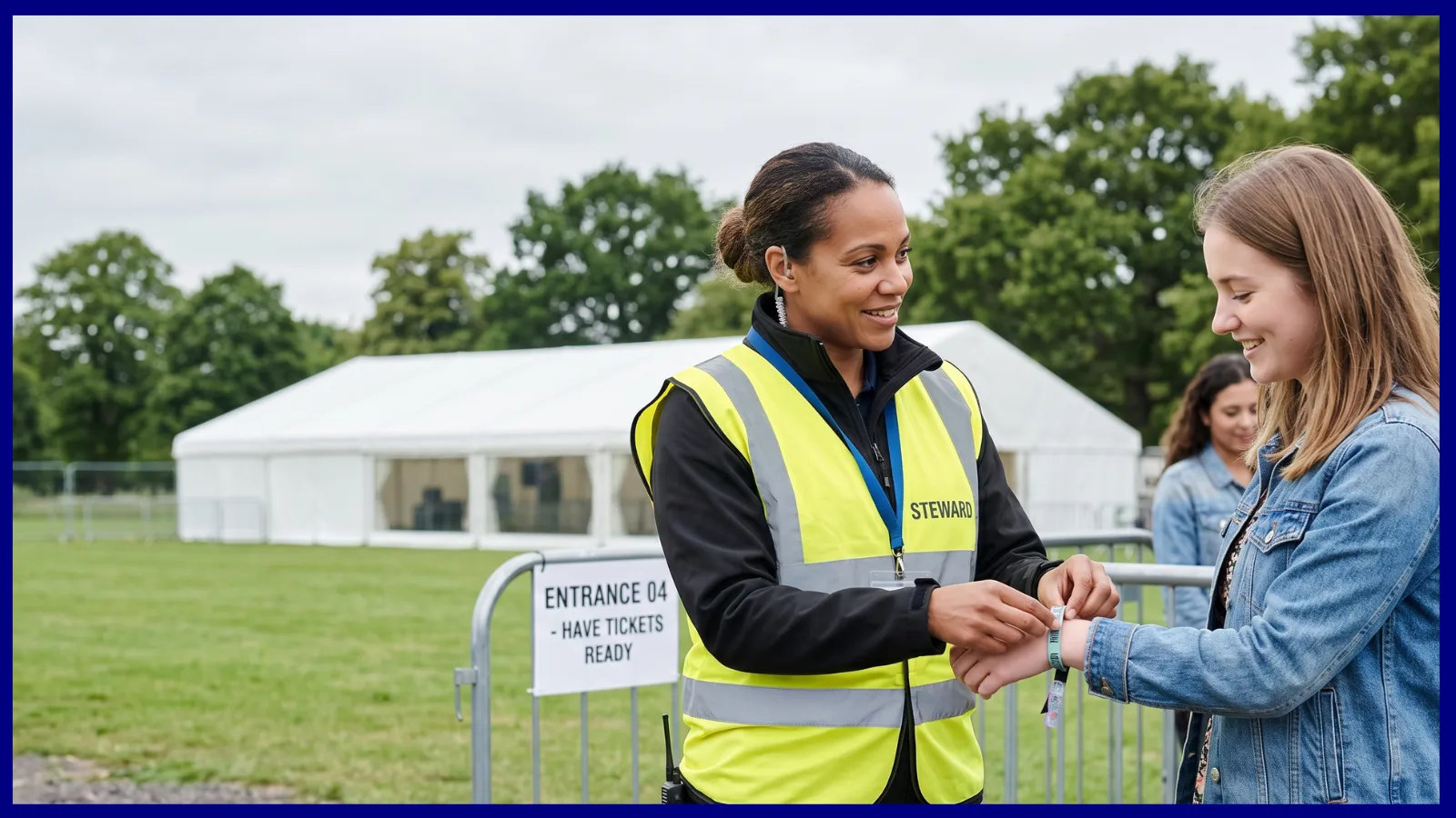 Event stewards in hi-vis managing an orderly queue at a venue entrance